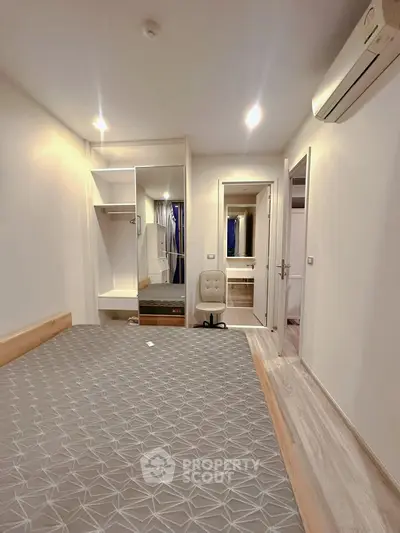 Modern bedroom with built-in wardrobe and air conditioning unit