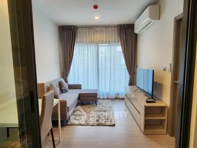 Modern living room with cozy sofa, TV, and large window with city view.