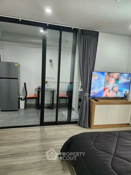 Modern studio apartment with open layout, featuring a sleek kitchen and cozy living area.