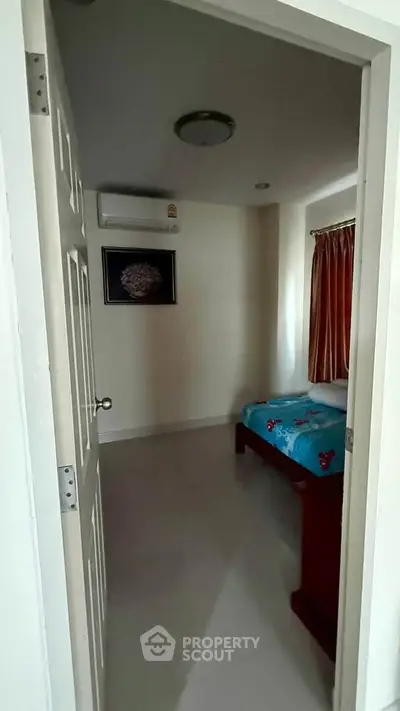 Cozy bedroom with air conditioning and natural light, perfect for relaxation.