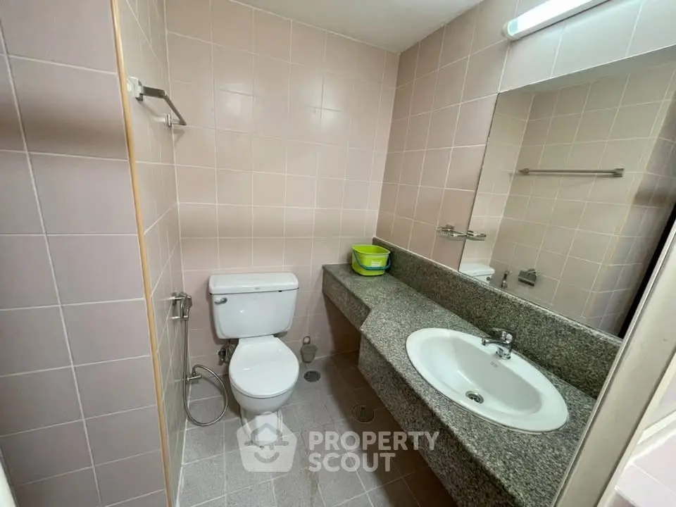Compact bathroom with modern fixtures and granite countertop in a cozy real estate property.