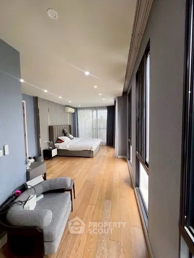 Spacious modern bedroom with large windows and elegant decor