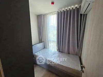 Cozy bedroom with large window and modern air conditioning unit