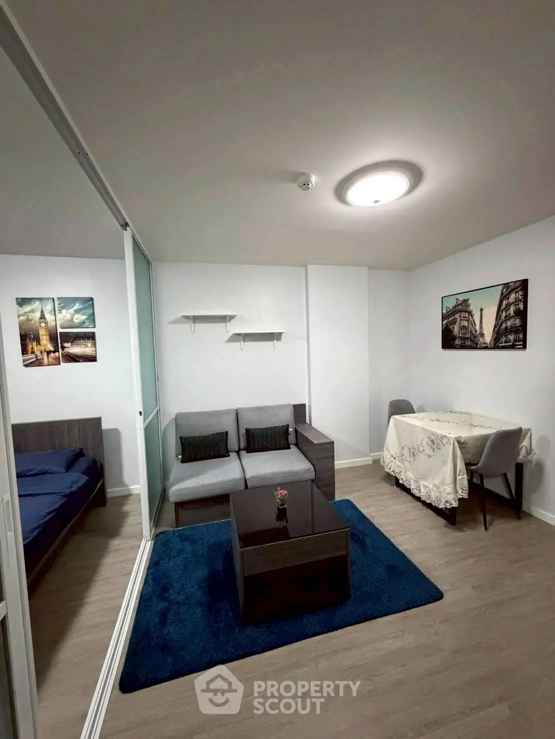 Modern living room with cozy sofa, dining area, and stylish decor