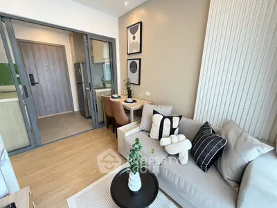 Modern living room with stylish decor and open kitchen layout in a contemporary apartment.