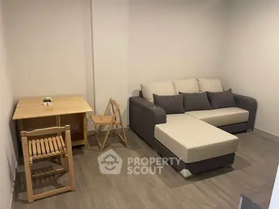 Cozy living room with modern sofa and wooden furniture, perfect for relaxation.