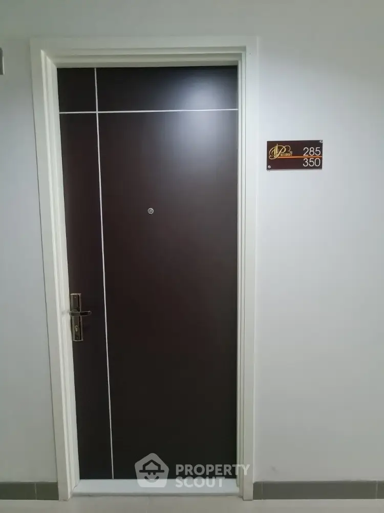 Modern apartment entrance door with sleek design and room number plaque