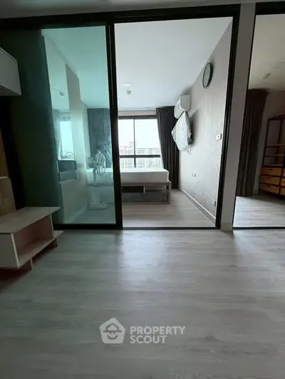 Modern bedroom with sliding glass doors and natural light