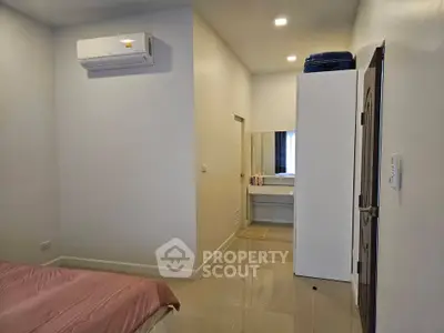 Cozy bedroom with air conditioning and modern furnishings, perfect for comfortable living.