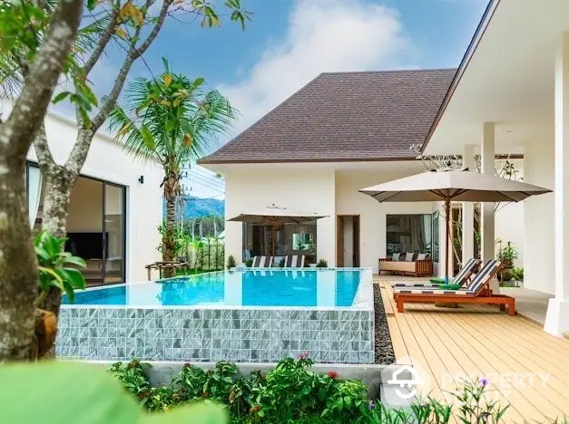 Luxurious villa with stunning pool and lush garden, perfect for relaxation and entertainment.