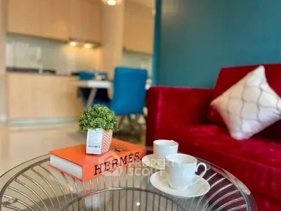 Stylish living room with vibrant red sofa and modern decor, perfect for urban living.