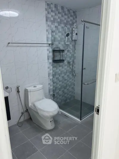 Modern bathroom with glass shower and tiled walls