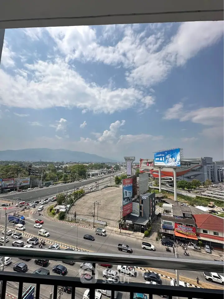 Stunning cityscape view from a high-rise balcony showcasing vibrant urban life and expansive skyline.