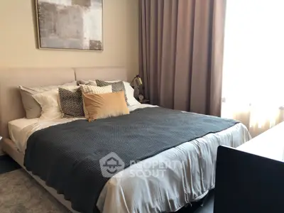 Cozy bedroom with elegant decor and natural light, perfect for relaxation and comfort.