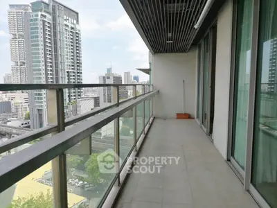 Spacious balcony with city skyline view in modern high-rise apartment