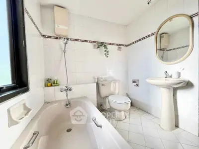 Bright and airy bathroom with bathtub and modern fixtures, perfect for relaxation.