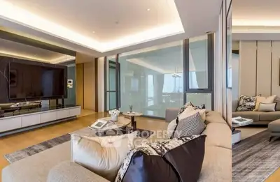 Luxurious modern living room with elegant decor and large TV, perfect for relaxation.