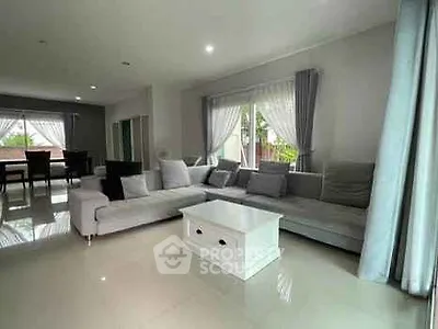 Spacious living room with modern gray sofa and natural light