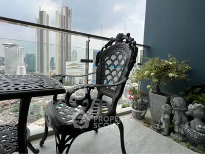 Stunning balcony with cityscape view and elegant wrought iron furniture.