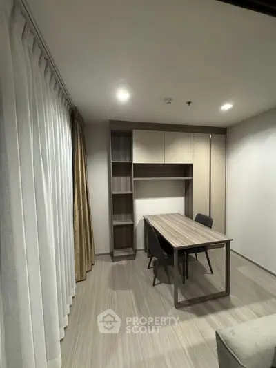 Modern study room with sleek wooden desk and built-in shelving, perfect for productivity and organization.