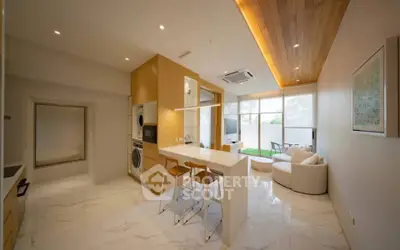 Modern open-layout kitchen and living room with sleek design and natural light