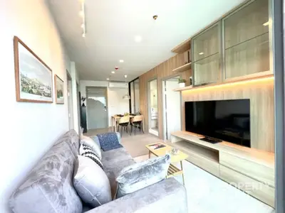 Modern living room with stylish decor and large TV unit in a bright apartment.