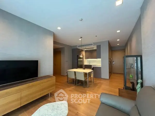 Modern living room with sleek furniture and open kitchen layout, perfect for contemporary living.