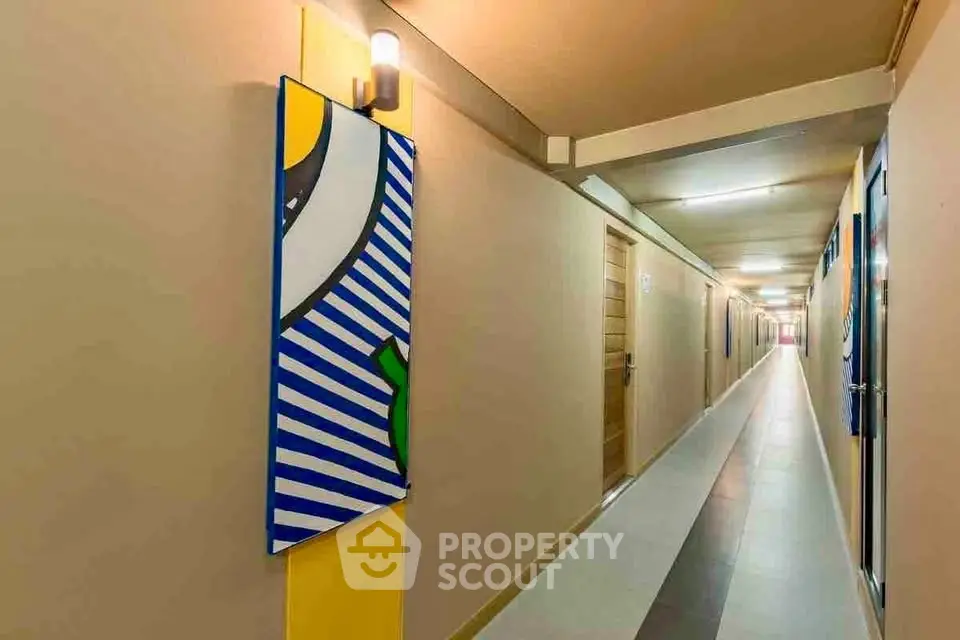 Modern apartment corridor with vibrant artwork and sleek lighting