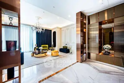 Luxurious living room with elegant decor and modern furnishings, featuring a chandelier and marble flooring.