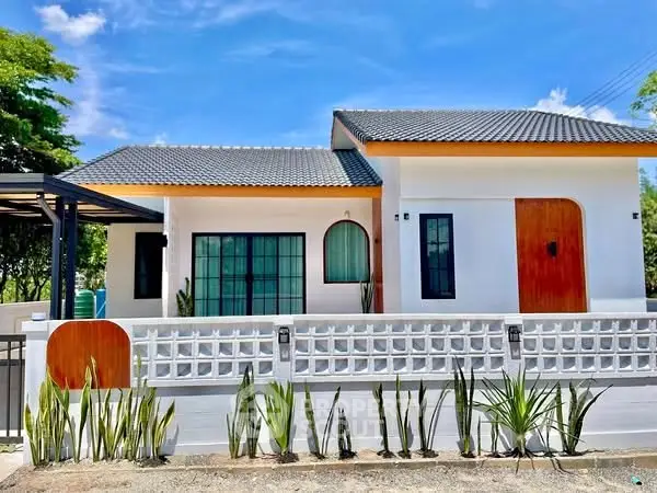 Charming modern house with sleek design and lush greenery, perfect for serene living.