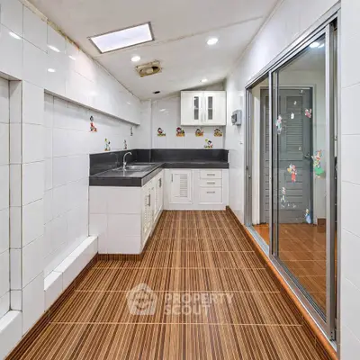 Spacious kitchen with modern design and ample storage in a stylish apartment.