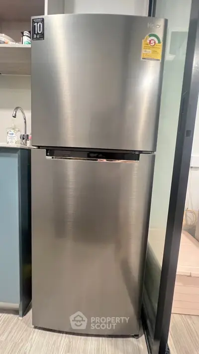 Modern stainless steel refrigerator in a sleek kitchen setting, perfect for contemporary homes.