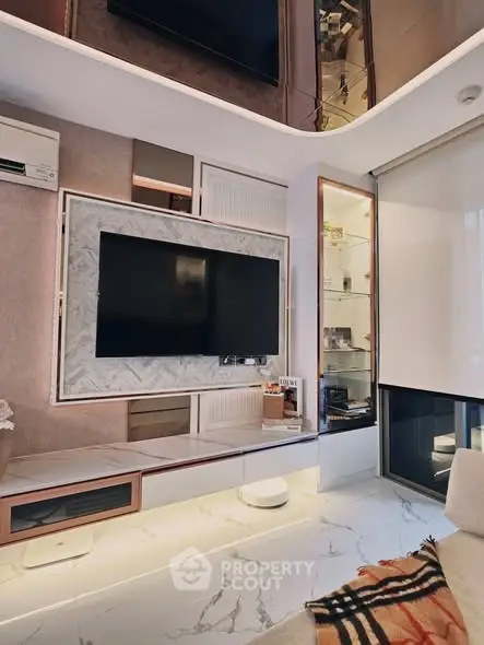 Modern living room with sleek design, marble flooring, and large TV setup, perfect for luxury urban living.