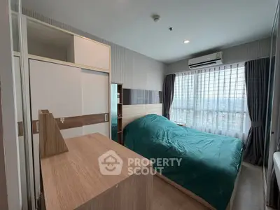 Modern bedroom with large window and stylish furnishings