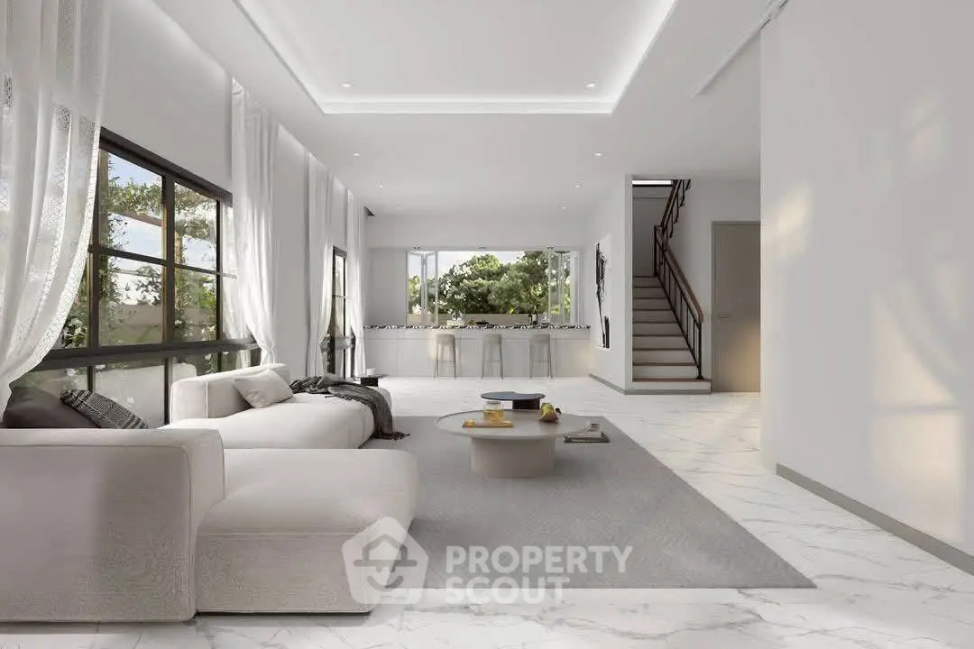 Luxurious open-plan living room with modern decor and large windows offering scenic views.