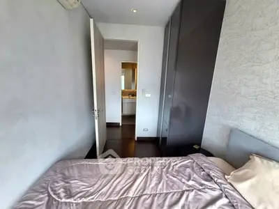Cozy bedroom with modern decor and partial view of en-suite bathroom