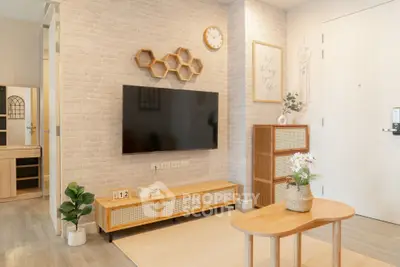 Modern living room with stylish decor, wall-mounted TV, and wooden furniture in a cozy apartment.