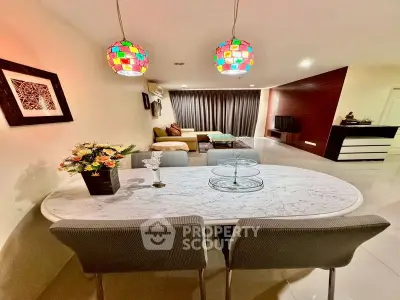 Stylish living room with modern decor and colorful pendant lights, perfect for cozy gatherings.