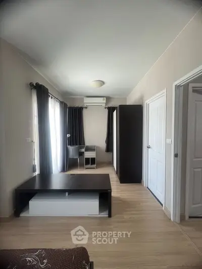 Spacious modern living room with sleek furniture and natural light.