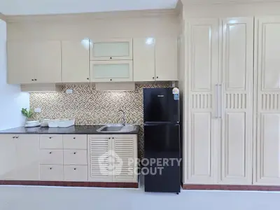 Modern kitchen with sleek cabinetry and mosaic backsplash