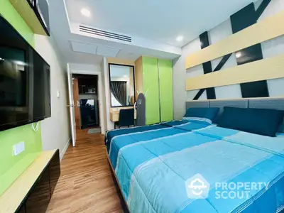 Modern bedroom with stylish decor and vibrant colors, featuring a cozy bed and sleek furnishings.