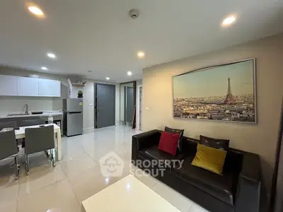 Modern open-plan living room with sleek kitchen and stylish decor