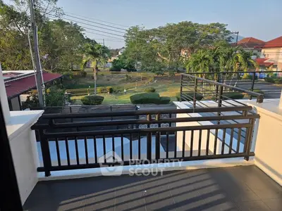 Spacious balcony with scenic garden view in a serene neighborhood.