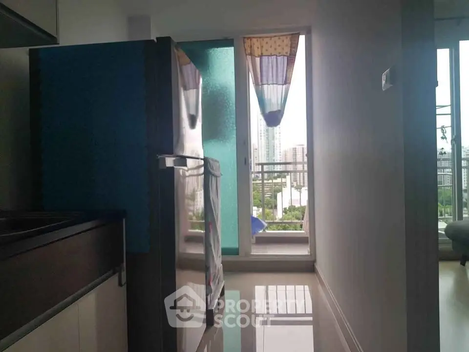 Modern kitchen with balcony view and sleek appliances in urban apartment