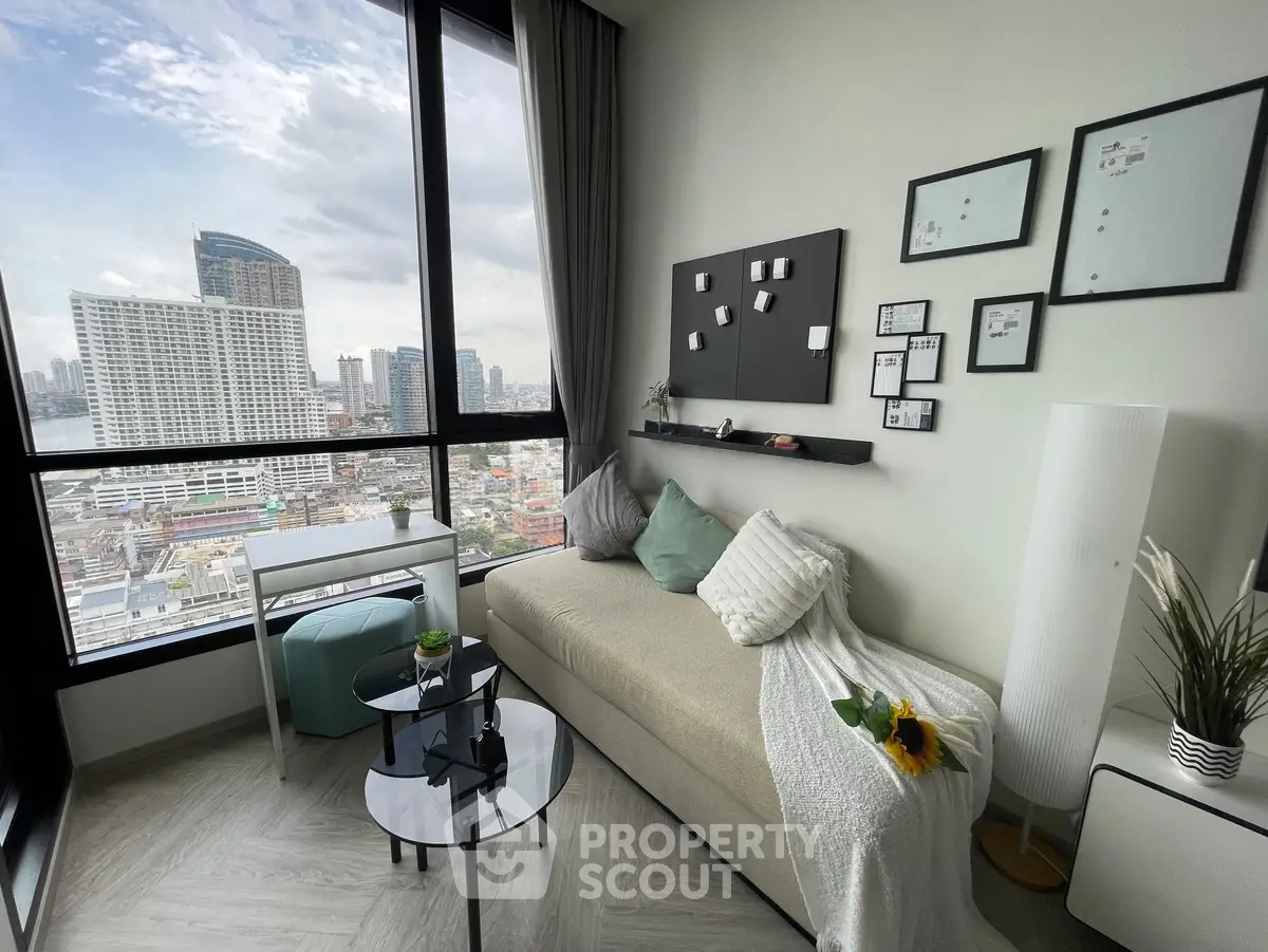 Modern living room with panoramic city view, stylish decor, and cozy seating area.