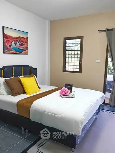 Cozy bedroom with stylish decor and natural light, perfect for relaxation and comfort.