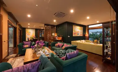 Luxurious living room with elegant decor and vibrant colors, featuring plush seating and ambient lighting.