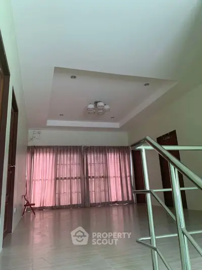 Spacious living room with modern ceiling lights and large windows