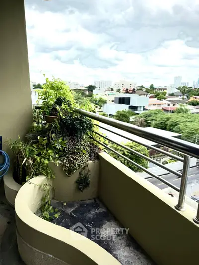 Charming balcony with lush greenery and city view, perfect for relaxation and enjoying urban living.