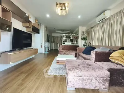 Spacious living room with modern decor and plush seating in a stylish apartment.